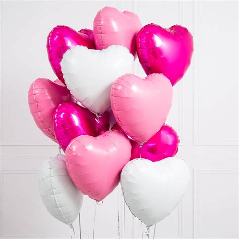 inflated one dozen pink and white heart foil balloons by bubblegum balloons | notonthehighstreet.com