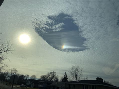 A tiny rainbow in this cloud hole : r/WeatherPorn