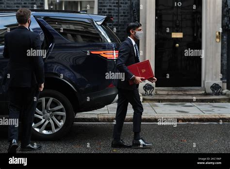 Chancellor of the Exchequer Rishi Sunak, wearing a face mask, arrives ...