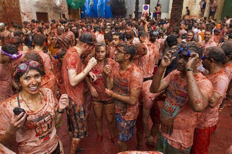 Revellers covered in tomato pulp take part in the annual “Tomatina ...