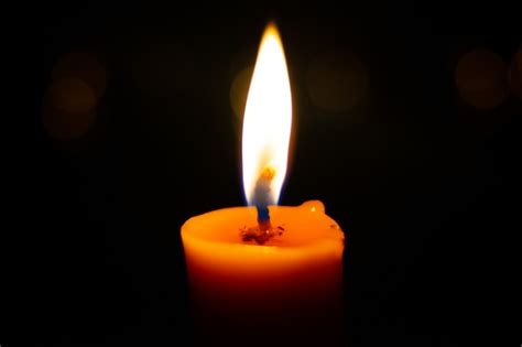 Premium Photo | One light candle burning brightly in the black background