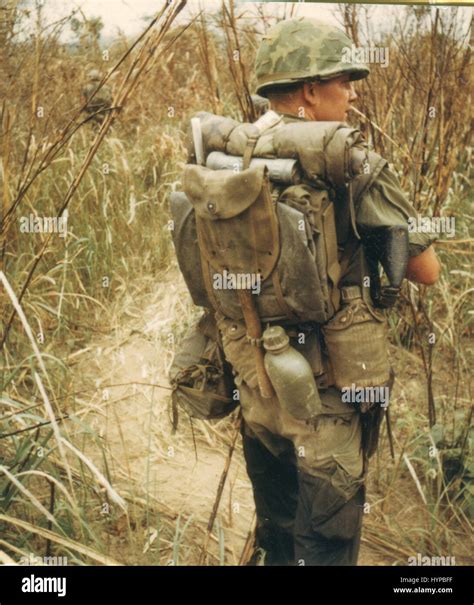 A US Navy hospital corpsman carries his belongings on his back as he serves in the Third Marine ...