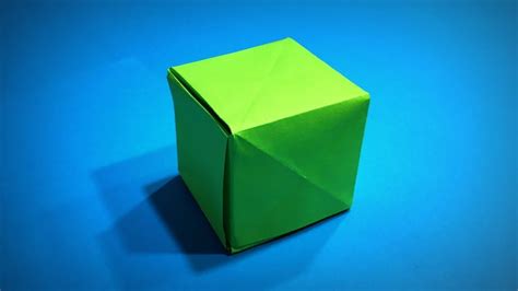 an origami cube on a blue background