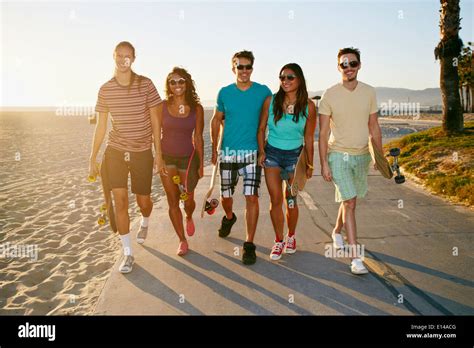 Friends walking together on beach Stock Photo - Alamy