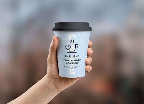 Free Coffee Paper Cup in Hand Mockup PSD - Good Mockups