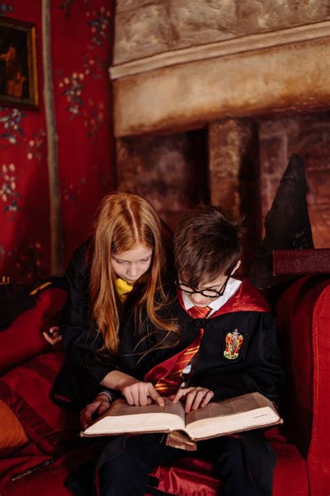 Children in Harry Potter Costumes Reading a Book Together · Free Stock ...