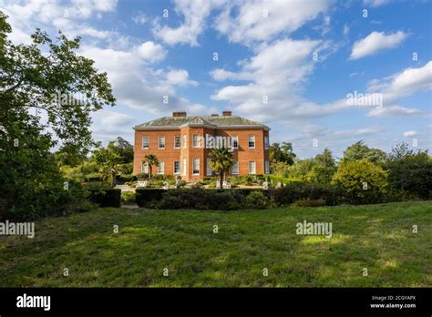 Side view of Hatchlands Park, a red-brick country house with surrounding gardens in East Clandon ...