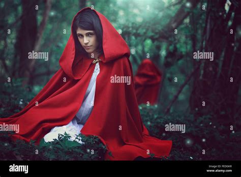 Dark little red riding hood in a surreal forest. Fantasy and fairy tale Stock Photo - Alamy