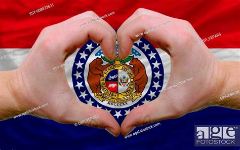 Gesture made by hands showing symbol of heart and love over us state flag of missouri, Stock ...