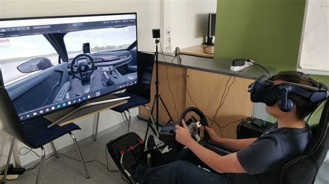 Demo setup with a virtual reality head-mounted display, steering wheel... | Download Scientific ...