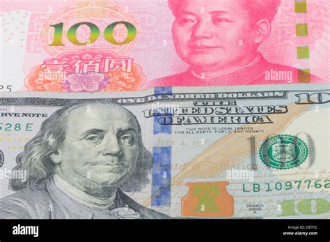 Chinese 100 Renminbi and 100 U.S. dollar bills piled on a white background Stock Photo - Alamy