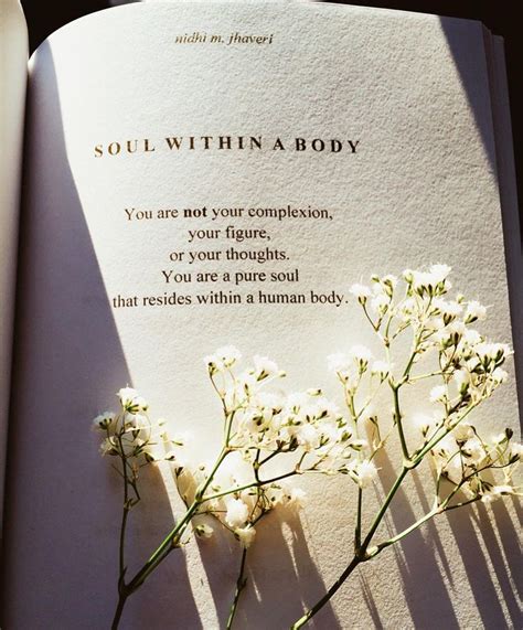 an open book with some flowers on it and the words, soul within a body