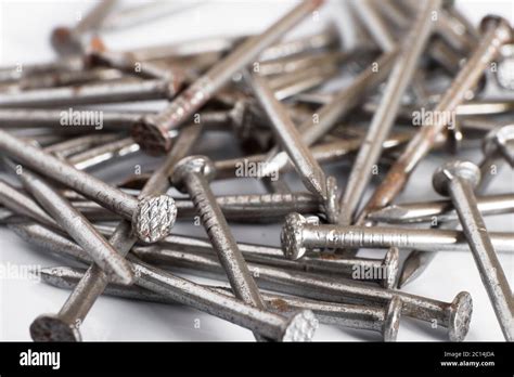 Iron rusty nails on a white background Stock Photo - Alamy