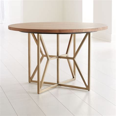 Shop Hayes 48" Round Acacia Dining Table. Hayes' open fretwork of angled brass tubing finds its ...