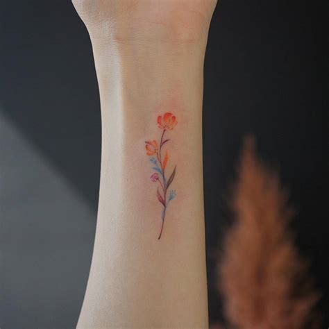 Small watercolor flower tattoo on the inner wrist - Tattoogrid.net