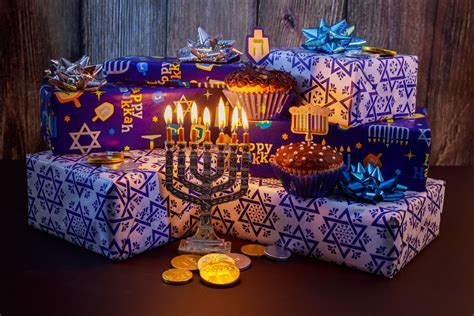 the menorah is next to many wrapped presents with lit candles on them ...