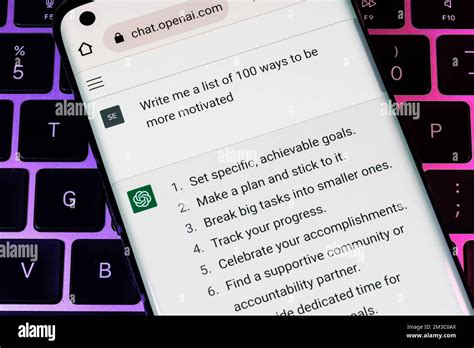 OPEN AI ChatGPT chat bot seen on smartphone placed on laptop. AI ...