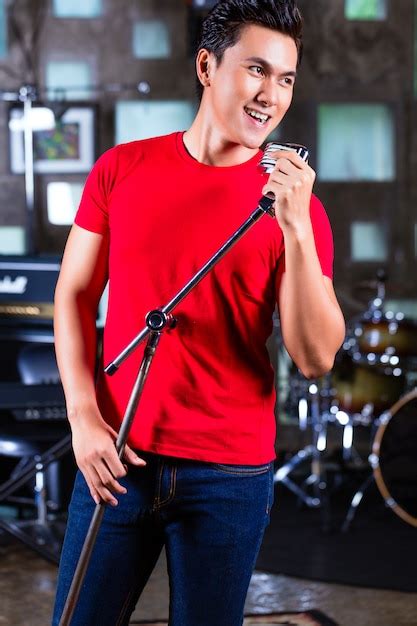 Premium Photo | Asian singer producing song in recording studio