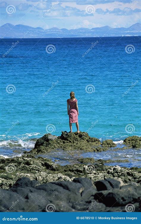 Young Woman Standing Rocks, Looking Out To Sea Stock Photo - Image of alone, blue: 6078510