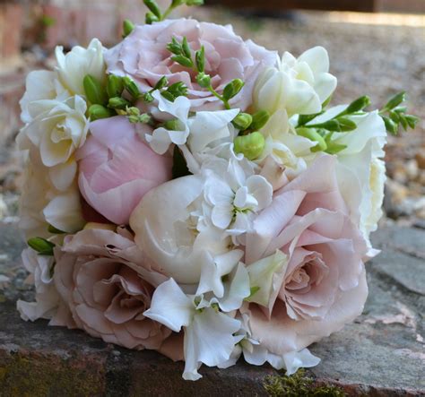 Bridal bouquet of white freesia, pale pink peony and quick sand roses ...