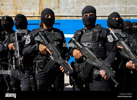 Members of the specialized Police anti-gang unit pose for pictures before leaving for an ...