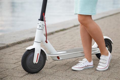 Female legs on the electric scooter 14406700 Stock Photo at Vecteezy