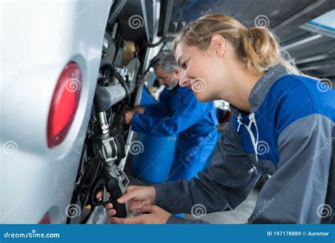 Female Auto Mechanic Smiling Repairing Bus Stock Image - Image of ...