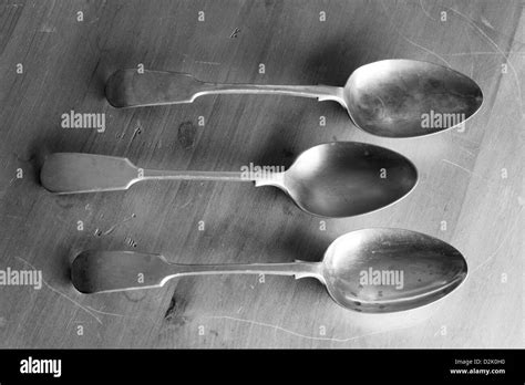Silver and EPNS spoons on pine kitchen table Stock Photo - Alamy