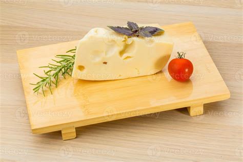 Maasdam cheese on wooden background 10878095 Stock Photo at Vecteezy