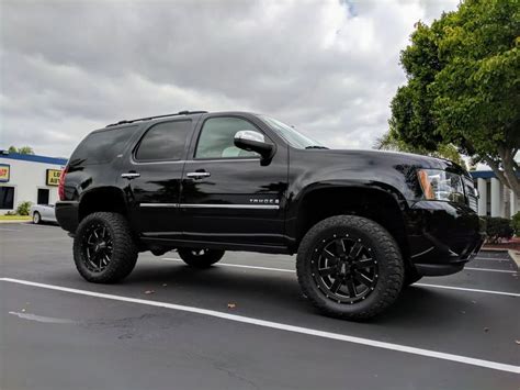 a black truck parked in a parking lot