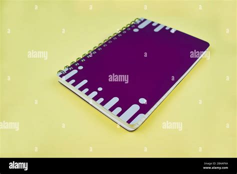Portrait of an purple note book diary with white stripes before an isolated white background ...