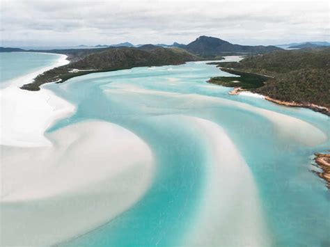 Aerial view of Whitehaven Beach at low tide, with sand banks forming a pattern in the water ...