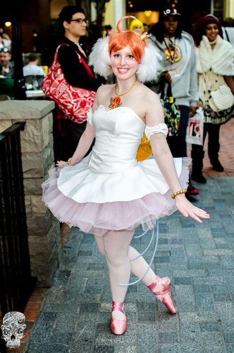 a woman in a white dress and pink shoes posing for the camera with ...