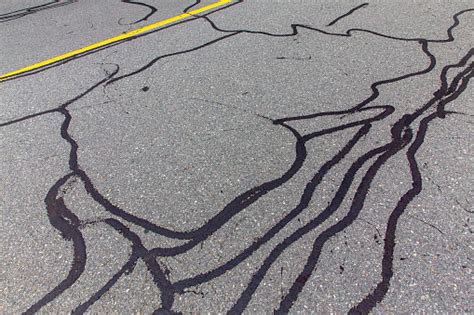 Asphalt Road With Filled Cracks Stock Photo - Download Image Now - iStock