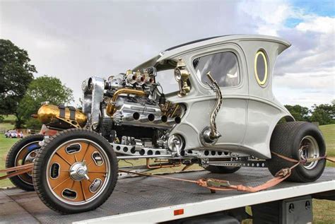 an antique car is being towed on a flatbed trailer