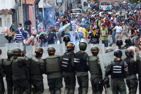 Venezuelan police officer shot dead and dozens injured as protests against Maduro escalate