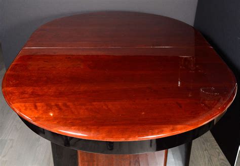 Art Deco Book-Matched Mahogany and Black Lacquer Oval Dining Table For Sale at 1stdibs