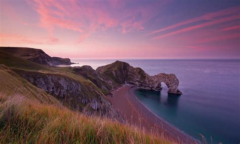 Durdle Door At Sunrise Photograph by Getty Images - Fine Art America