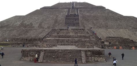 people are walking around in front of the pyramid