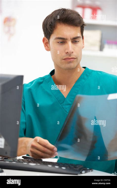 Young hospital doctor at desk Stock Photo - Alamy