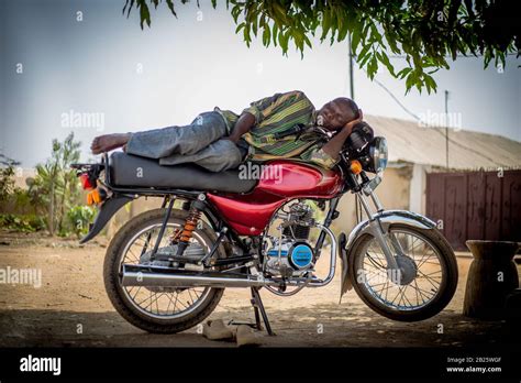 Motorcycle taxi (okada) drivers take a nap on their bikes in Nigeria Stock Photo - Alamy