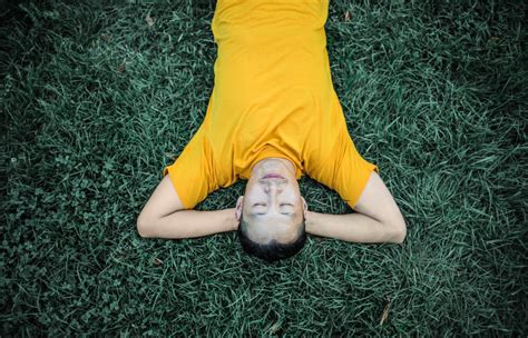 Photo of Person Laying On Grass Field · Free Stock Photo