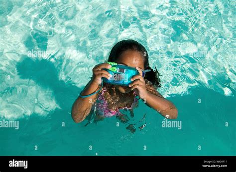 Girl Using Waterproof Camera in Swimming Pool Stock Photo - Alamy
