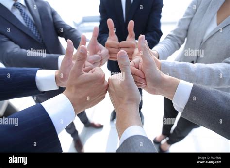 business team showing thumbs up Stock Photo - Alamy