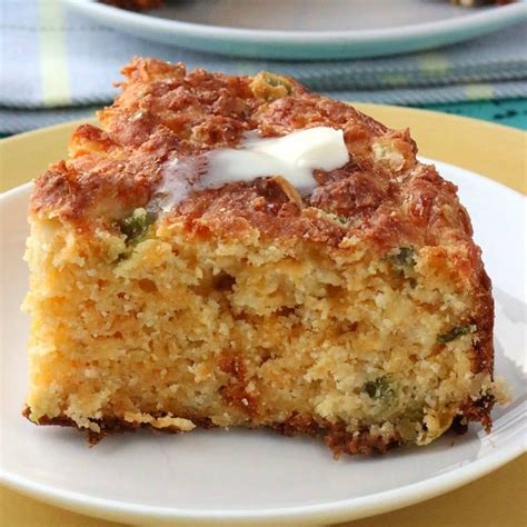 a piece of cake sitting on top of a white plate next to another plate filled with food