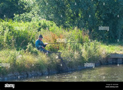 Man fishing on the Norfolk Broads Stock Photo - Alamy