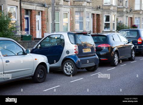 Smart car parallel parked sideways in a tight parking space Stock Photo - Alamy