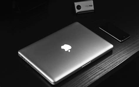 Royalty-Free photo: Silver MacBook on table beside smartphone | PickPik