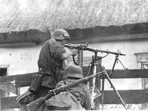 A soldier from the "Germania" regiment of the Waffen-SS Division Wiking fires an MG 34 from a ...