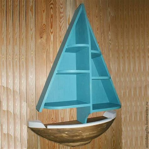 a blue boat shaped book shelf on top of a wooden wall